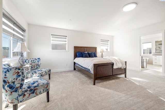 bedroom featuring light carpet and baseboards