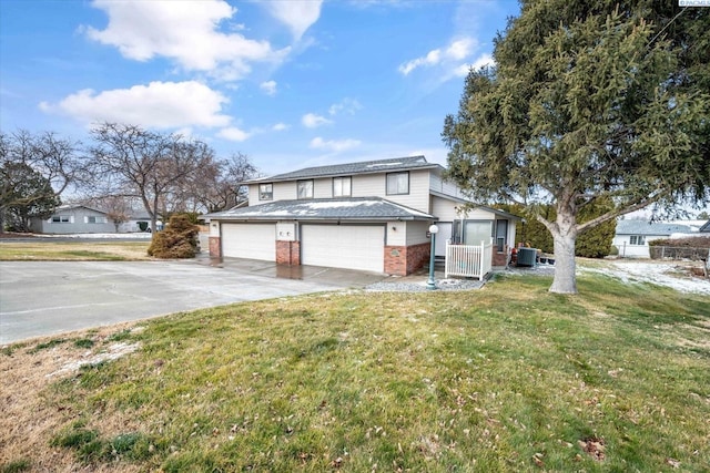 front of property featuring central AC, a garage, and a front lawn