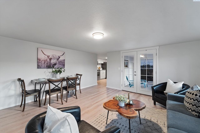 living room with french doors, wood finished floors, and baseboards