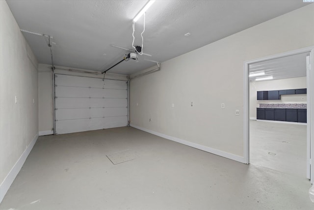 garage with a garage door opener and baseboards