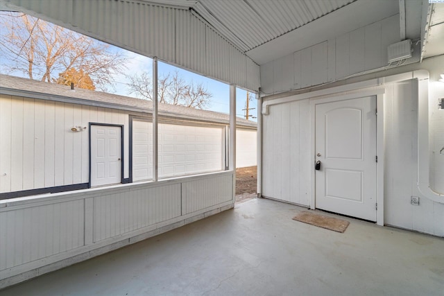 unfurnished sunroom featuring vaulted ceiling