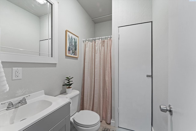 bathroom with vanity, toilet, and a shower with curtain