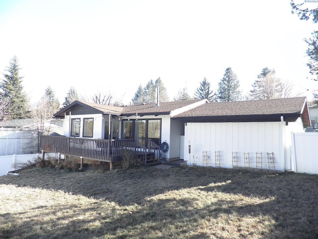 back of house with a yard and a deck