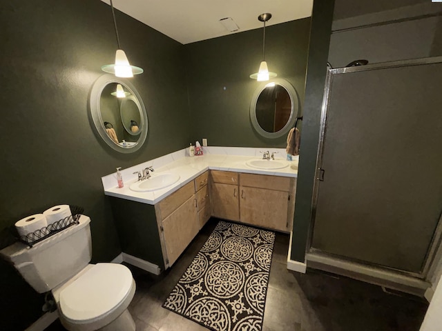 bathroom with vanity, toilet, a shower with door, and tile patterned flooring