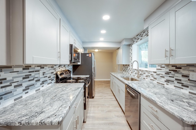 340-342 NW N St, Pullman, WA 99163 - kitchen with tasteful backsplash, a sink, stainless steel appliances, light wood-type flooring, and recessed lighting