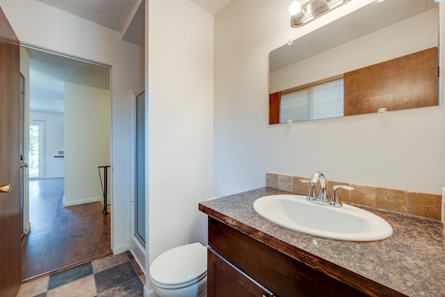340-342 NW N St, Pullman, WA 99163 - full bathroom with toilet, vanity, a shower with door, and baseboards