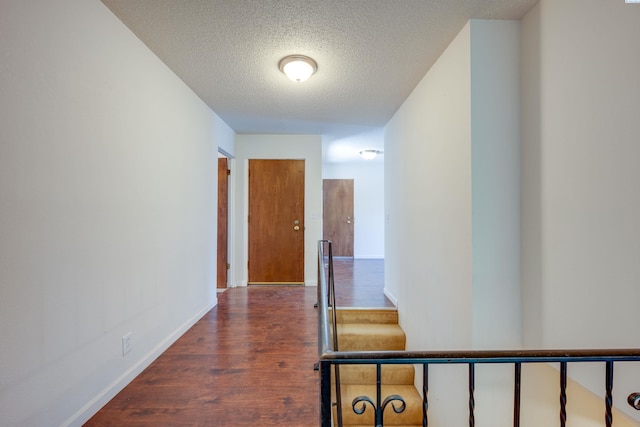 340-342 NW N St, Pullman, WA 99163 - hallway featuring a textured ceiling, wood finished floors, and baseboards