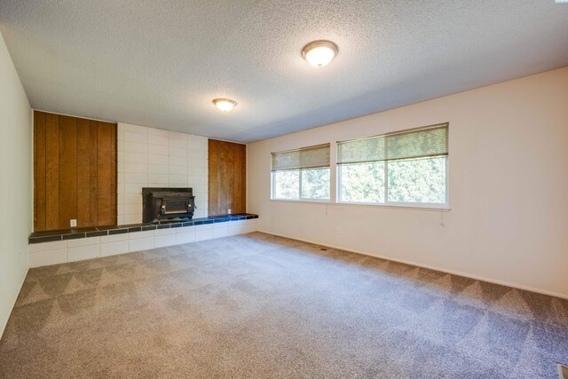340-342 NW N St, Pullman, WA 99163 - unfurnished living room with a wood stove, a textured ceiling, and carpet flooring