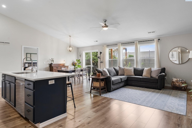 1707 W 25th Pl, Kennewick, WA 99337 - kitchen featuring a sink, open floor plan, ceiling fan, light wood-style floors, and lofted ceiling
