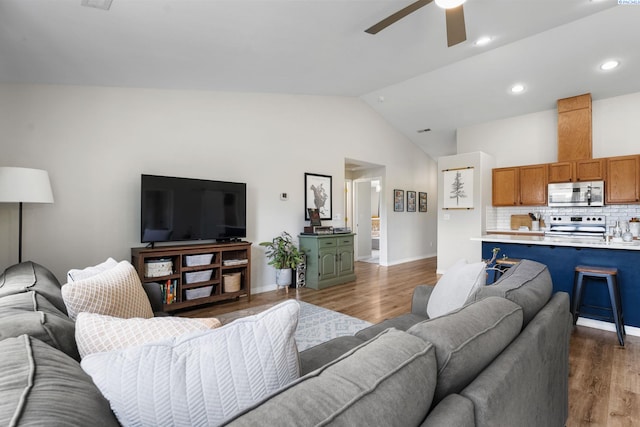1707 W 25th Pl, Kennewick, WA 99337 - living area with a ceiling fan, wood finished floors, vaulted ceiling, and baseboards
