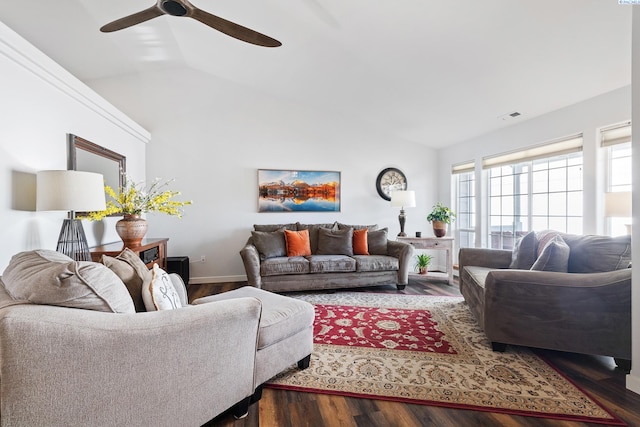 living area featuring dark wood-style floors, lofted ceiling, visible vents, ceiling fan, and baseboards