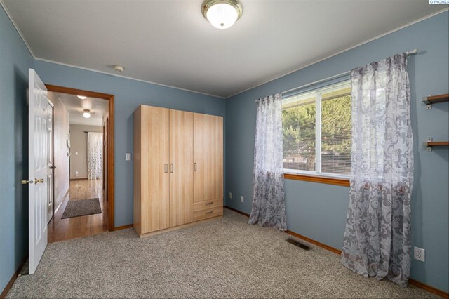 2302 W 31st Ave, Kennewick, WA 99337 - unfurnished bedroom with baseboards, carpet flooring, a closet, and ornamental molding