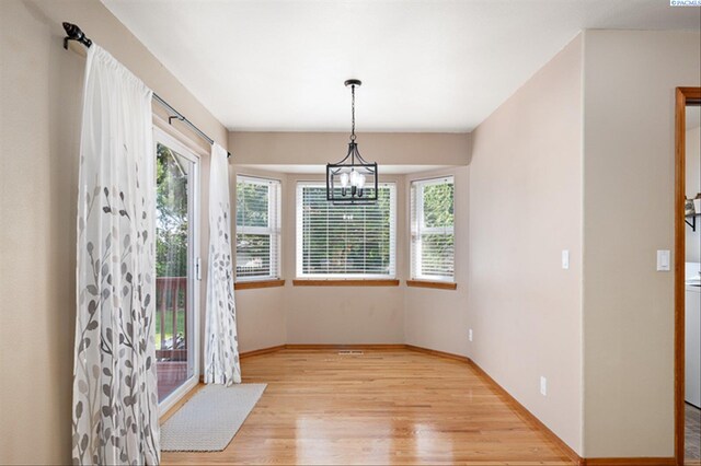 2302 W 31st Ave, Kennewick, WA 99337 - unfurnished dining area featuring light wood-type flooring, a chandelier, and baseboards