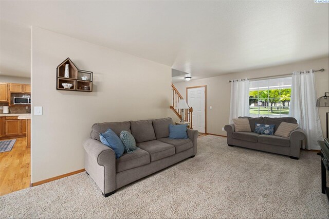 2302 W 31st Ave, Kennewick, WA 99337 - living room with stairway, baseboards, and light carpet