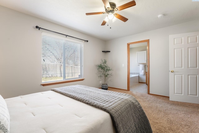 bedroom with a ceiling fan, carpet, baseboards, and connected bathroom