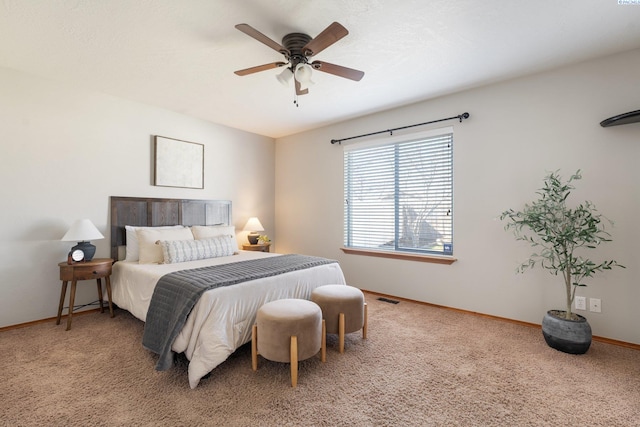 carpeted bedroom featuring visible vents, a ceiling fan, and baseboards