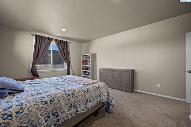 carpeted bedroom with a textured ceiling and baseboards