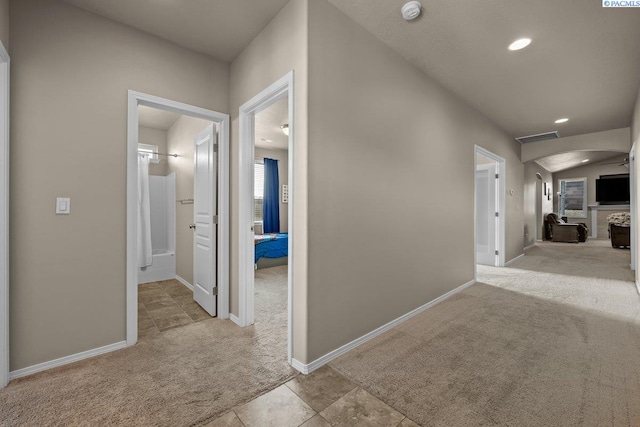 hall with arched walkways, carpet flooring, baseboards, and recessed lighting