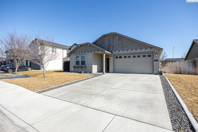 single story home featuring driveway, a garage, fence, and a front lawn