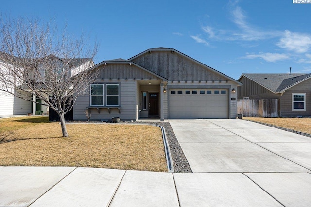 ranch-style house featuring a garage, a front yard, and driveway