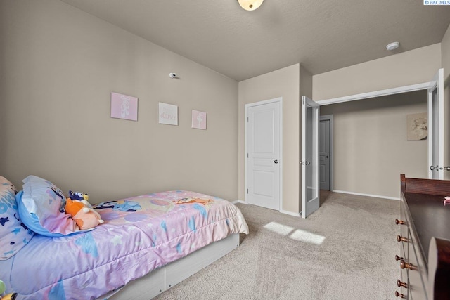 bedroom with carpet floors, a textured ceiling, and baseboards