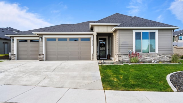 6012 W 31st Ave, Kennewick, WA 99336 - view of front of house with stone siding, a garage, concrete driveway, and a front lawn