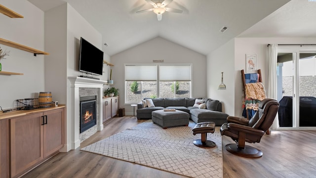 6012 W 31st Ave, Kennewick, WA 99336 - living room with a ceiling fan, a glass covered fireplace, plenty of natural light, wood finished floors, and vaulted ceiling