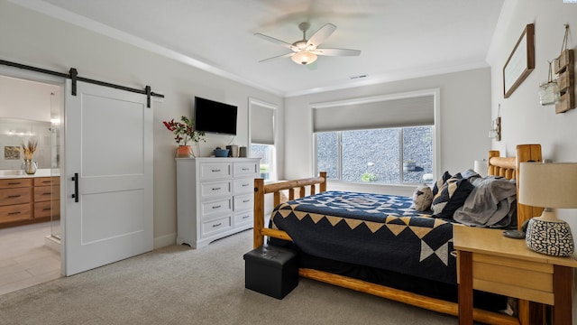 6012 W 31st Ave, Kennewick, WA 99336 - bedroom with a barn door, ensuite bath, crown molding, ceiling fan, and light carpet