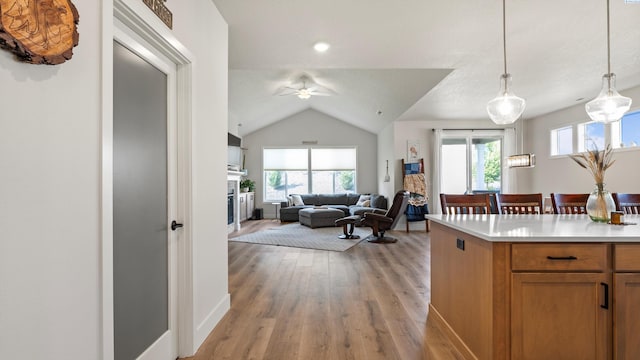 6012 W 31st Ave, Kennewick, WA 99336 - kitchen featuring healthy amount of natural light, a ceiling fan, light wood-type flooring, light countertops, and vaulted ceiling