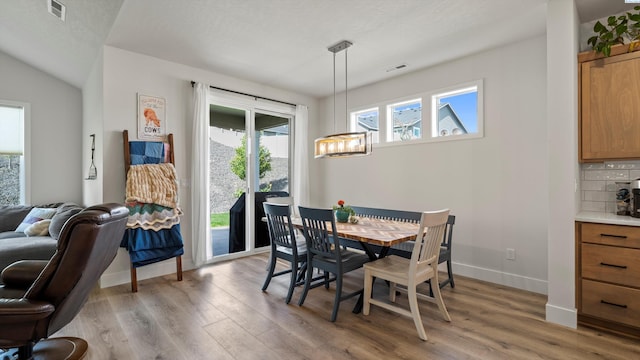 6012 W 31st Ave, Kennewick, WA 99336 - dining space with light wood-style flooring, baseboards, and a chandelier