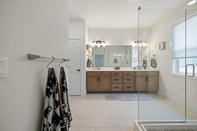 full bathroom with a stall shower, tile patterned flooring, double vanity, and baseboards