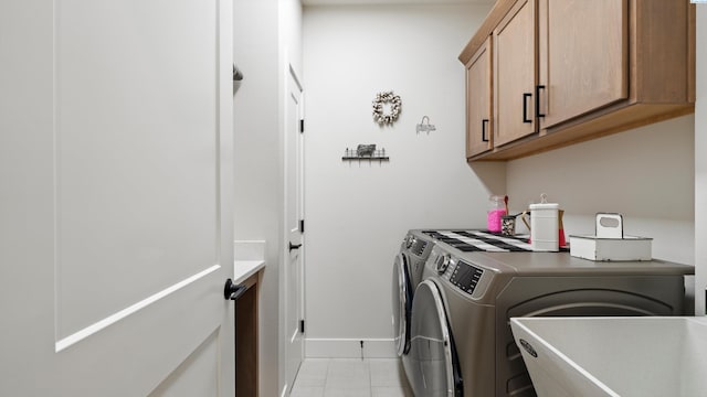 6012 W 31st Ave, Kennewick, WA 99336 - laundry room with washer and clothes dryer, cabinet space, light tile patterned floors, and baseboards