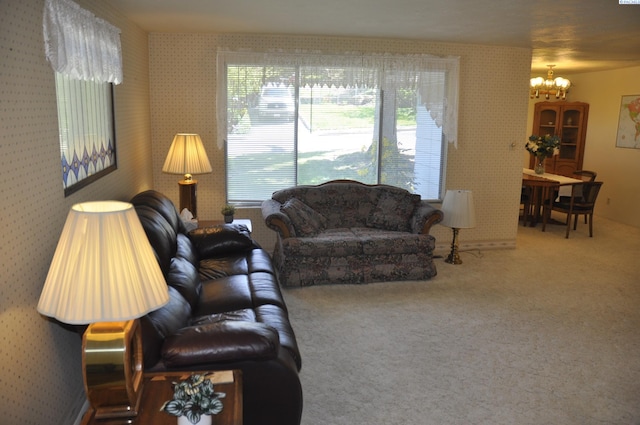 living room featuring wallpapered walls, an inviting chandelier, and carpet