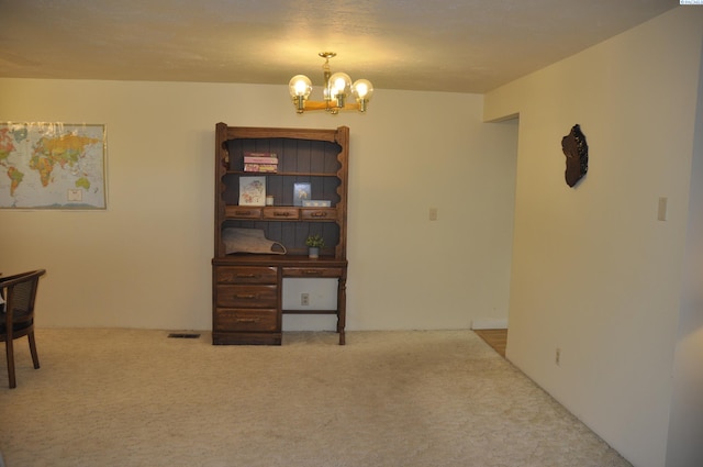 interior space with carpet floors and a notable chandelier