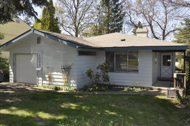 view of front of property with a front lawn, roof with shingles, and a chimney