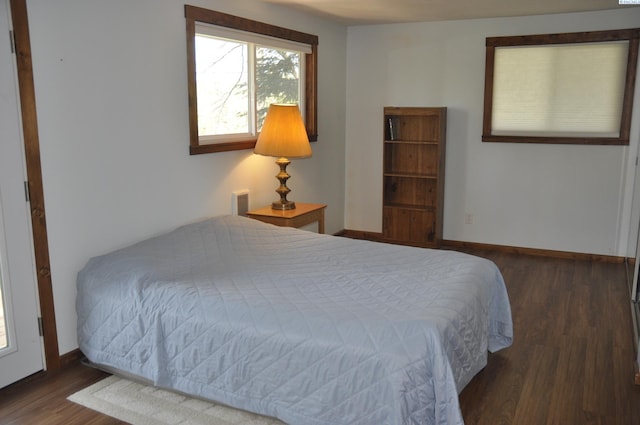 bedroom featuring baseboards and wood finished floors