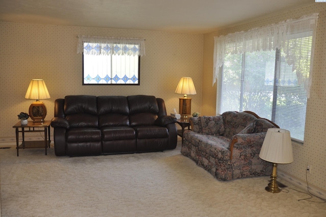 carpeted living area with wallpapered walls
