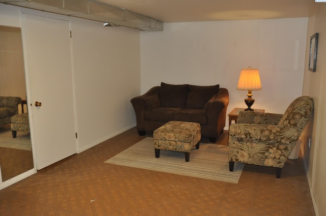 living area featuring baseboards and carpet flooring