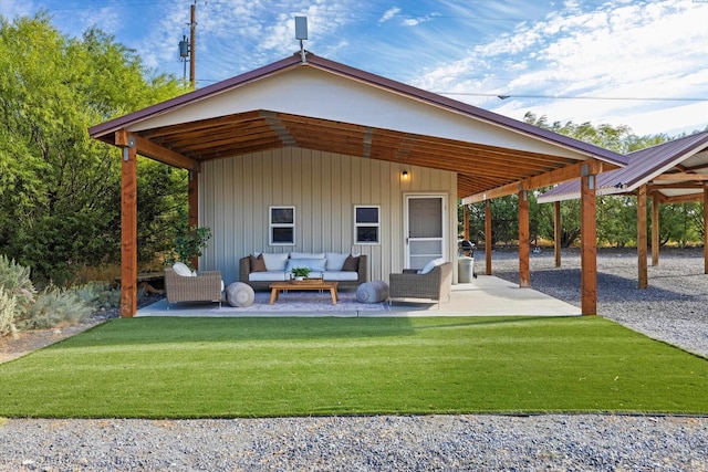 rear view of house with an outdoor living space, a yard, and a patio