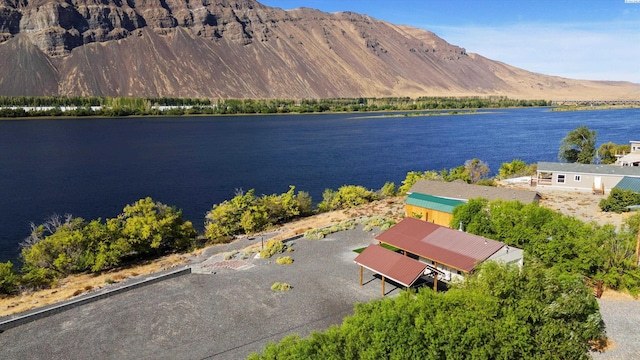 birds eye view of property with a water and mountain view