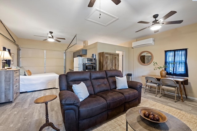 living room featuring a wall mounted air conditioner, ceiling fan, and light hardwood / wood-style flooring