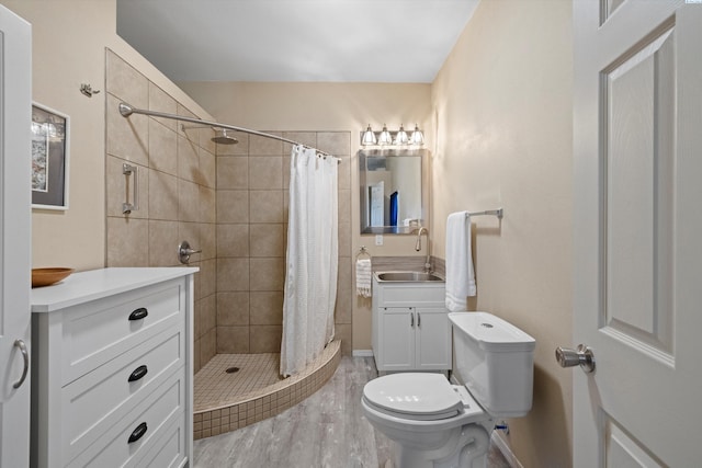 bathroom with vanity, wood-type flooring, toilet, and a shower with shower curtain