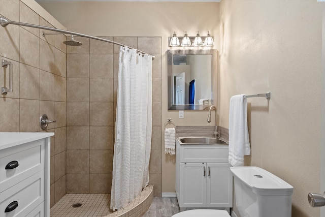 bathroom featuring toilet, vanity, and a shower with shower curtain