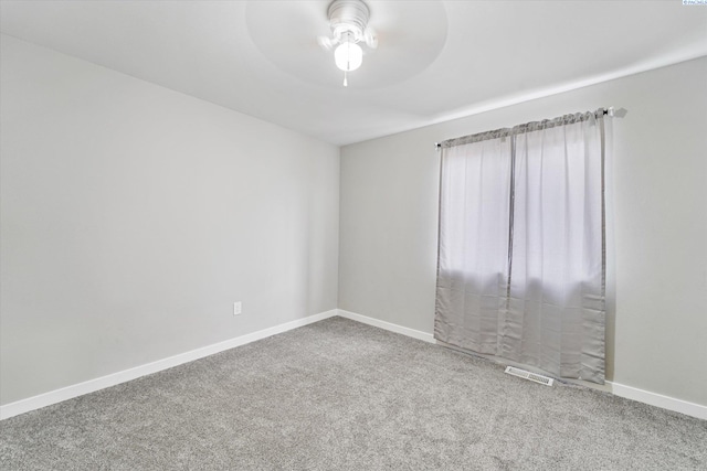 spare room with carpet floors and ceiling fan