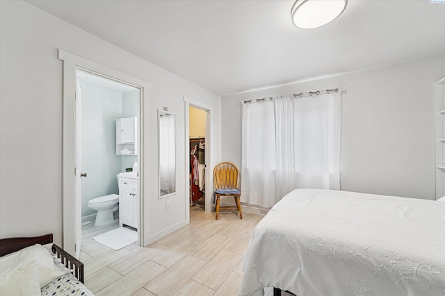 bedroom featuring connected bathroom, a spacious closet, and a closet