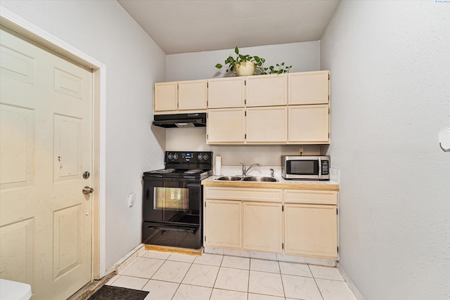 kitchen featuring black range with electric cooktop, light tile patterned floors, and sink