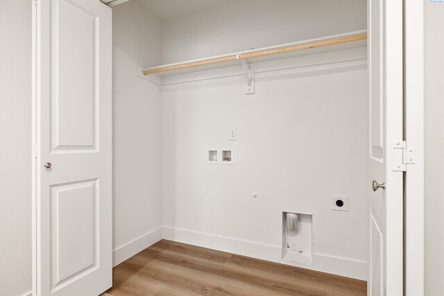 clothes washing area with gas dryer hookup, electric dryer hookup, hookup for a washing machine, and light wood-type flooring