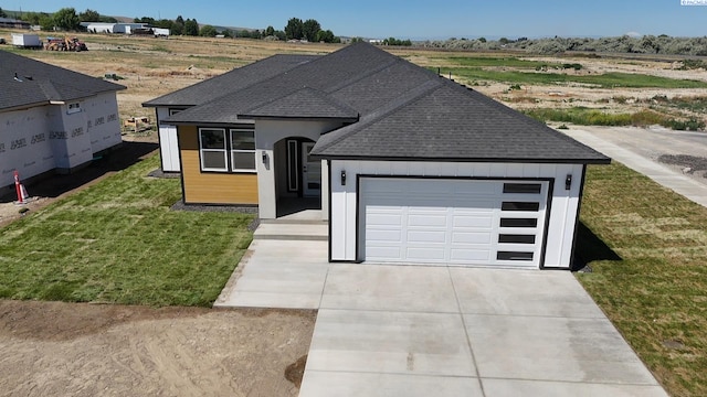 301 Victoria St, Sunnyside, WA 98944 - view of front of house featuring roof with shingles, an attached garage, concrete driveway, and a front yard