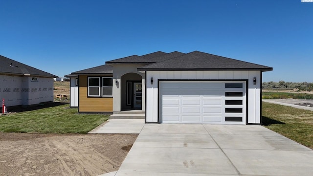 301 Victoria St, Sunnyside, WA 98944 - view of front of property featuring concrete driveway, roof with shingles, an attached garage, and a front lawn