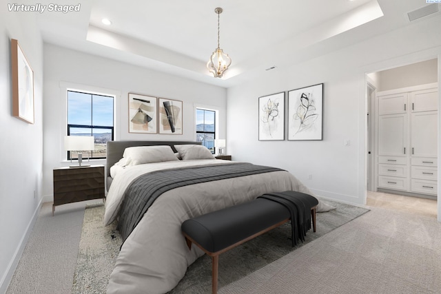 bedroom with recessed lighting, light colored carpet, visible vents, baseboards, and a raised ceiling